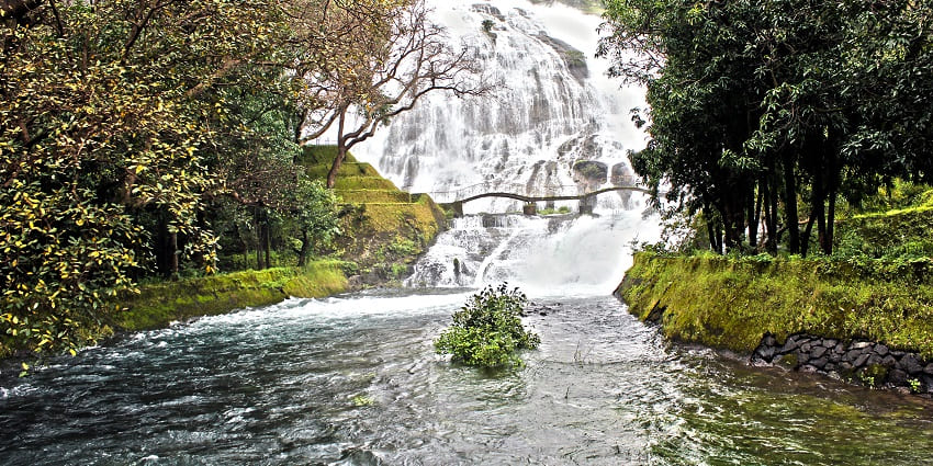 Bhandardara waterfalls surrounded by misty hills during the monsoon season in Maharashtra