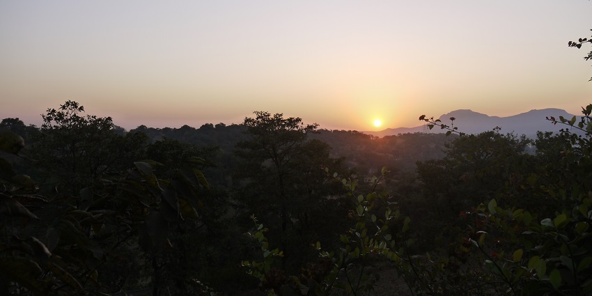 A beautiful sunrise over Sherdi, Bhandardara, with vibrant orange and pink hues
