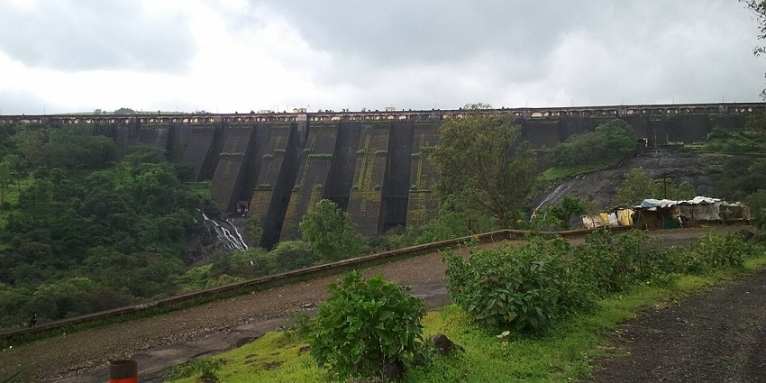 Scenic view of Wilson Bhandardara Dam with greenery, a famous place near Thanale Caves.