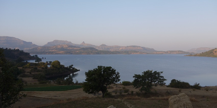 Bhandardara Lake, a scenic spot with lush green hills, one of the famous places near Jivdhan Fort.