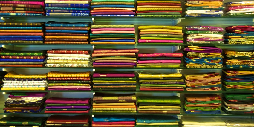 An inside view of a saree shop in Dadar showing the shelves filled with a plethora of colourful sarees