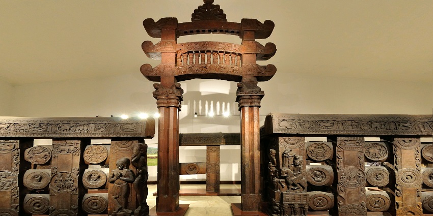 An image view of the ruins of Bharhut Stupa, showcasing intricate carvings and serene surroundings.