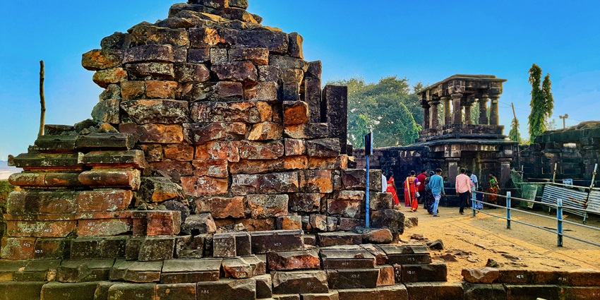 A picture of the ruins of an ancient temple with numerous devotees seeking blessings