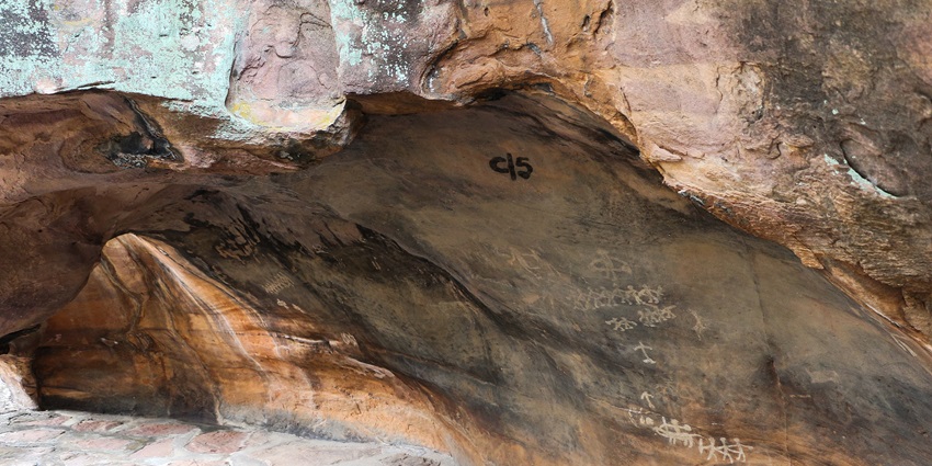 Ancient caves with prehistoric rock paintings, showcasing early human civilization, one of the best places to visit Madhya Pradesh for couples.