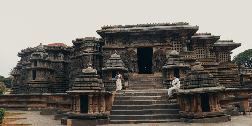 -People standing before a majestic temple, one of the best places near Shirgaon Fort