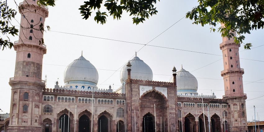A white dome-shaped building under a clear daytime sky, showcasing classic architectural details