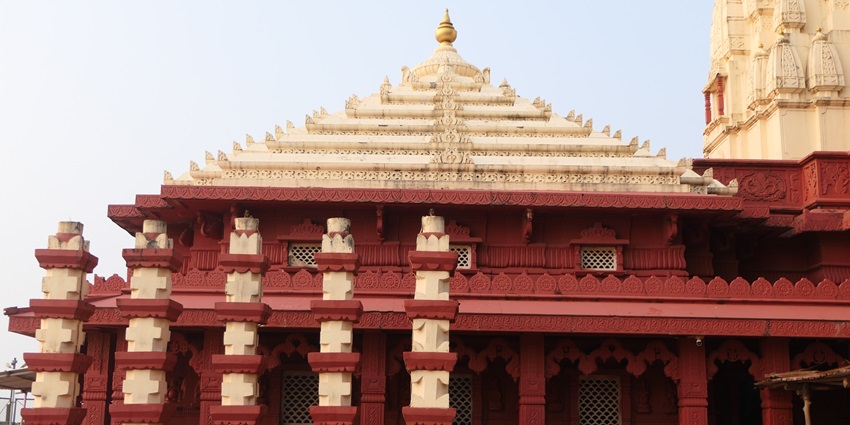 A view of the temple made of stone with red and yellow colour near Lohegaon water park.