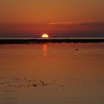 A stunning sunset at Bingin Beach, with bright blue waters and golden sands-an adventurer's paradise