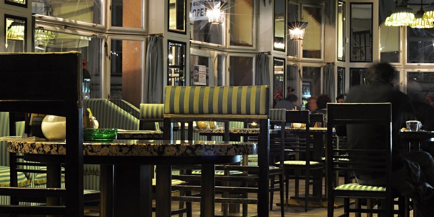 Trendy bar featuring lively music and a vibrant crowd.