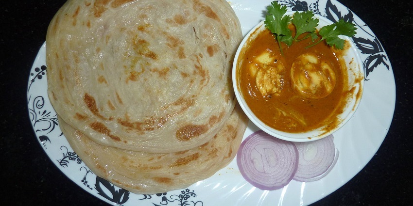 Image of Parotta with Egg Kurma and Onion Slices - Popular for its spicy biryani and hearty Indian meals