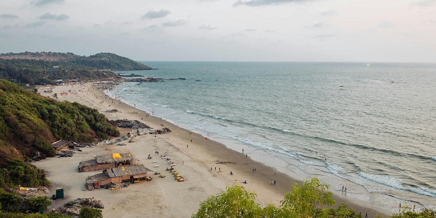 Aerial view of the Bordi Beach with waves crashing the sandy shores.
