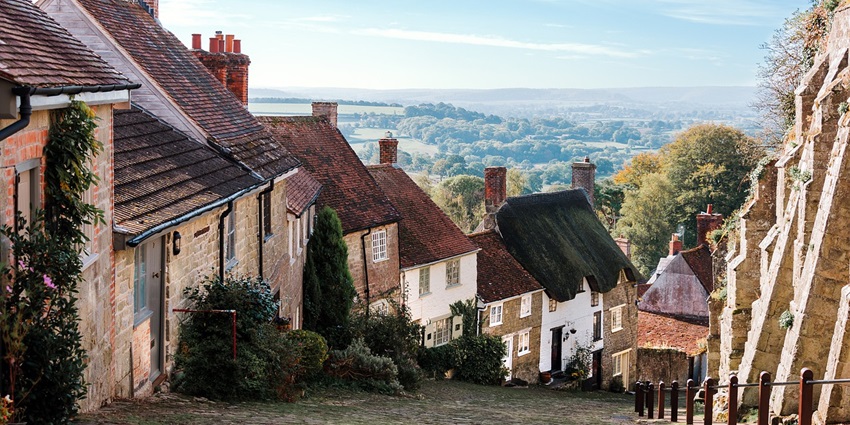 Charming old village houses lining a narrow street with rustic architectural details.