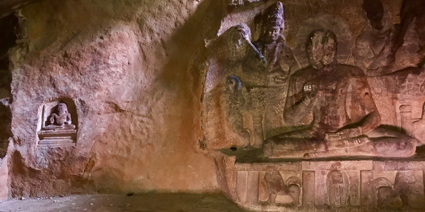 Defaced sculpture of a meditating yogi, one of the best attractions near Kanheri caves.