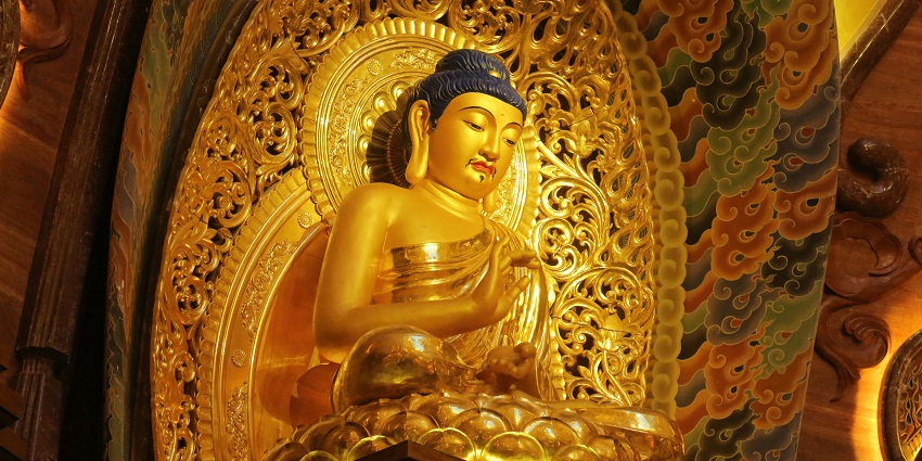 Cross-legged Buddha statue in a serene pose, reflecting Thonnakkal's shrine beauty.