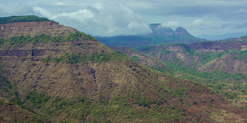 An awe- inspiring view of Camel Valley featuring majestic peaks and lush greenery.