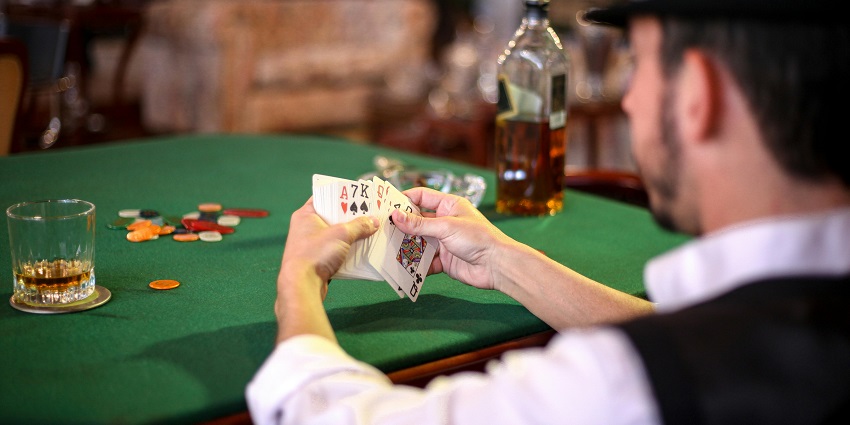 Snapshot of a man holding the deck of card in the iconic Carnival City Casino