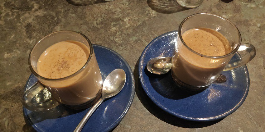 Two cups of masala chai served in glass cups, among the best street food in Koregaon Park.