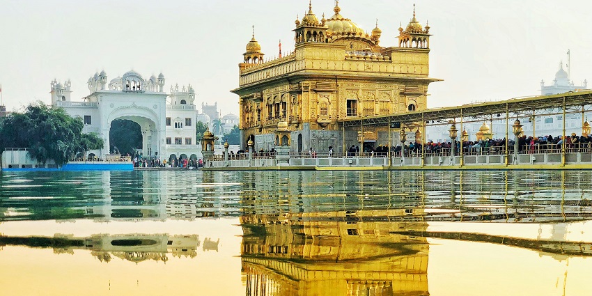 Yellow temple by the water, a stunning destination for road trips from Chandigarh.