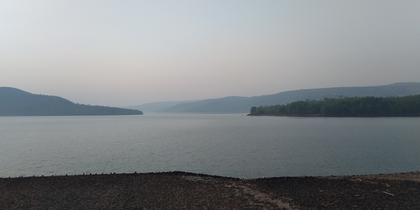 A scenic view of Chandoli Dam surrounded by greenery in Sangli, Maharashtra.