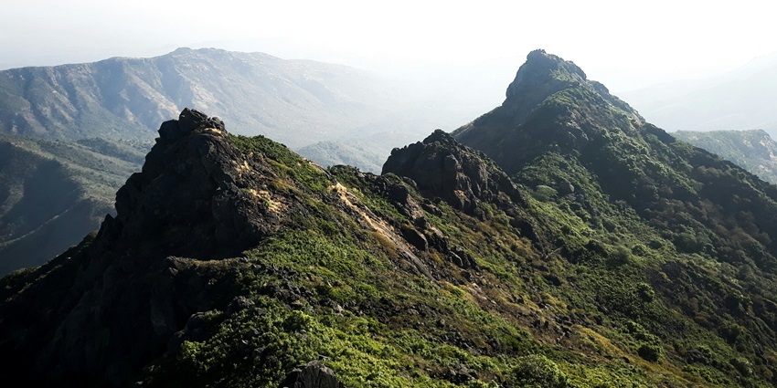 Scenic view of Chandragiri hill, lush meadows spanning with the clear blue sky in the background
