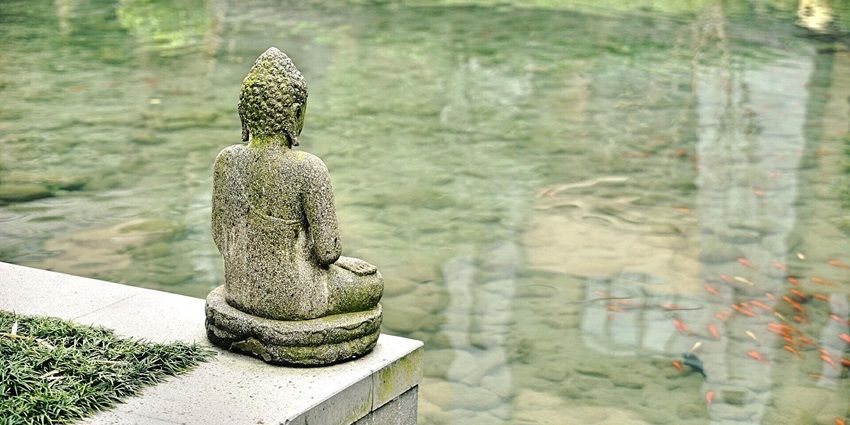 Image of a buddha statue on a wall facing back side - Chaneti Tomb is an ancient dome shape structure