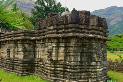 Image of Kukadeshwar Temple at Chavand with scattered stone structures and walls.