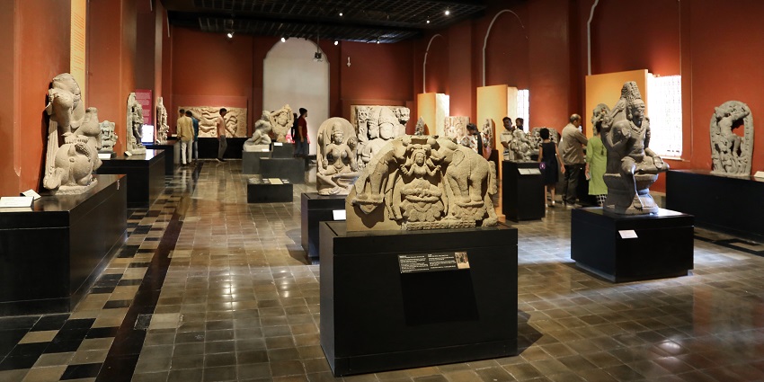 People looking at the various exhibits displayed in Chhatrapati Shivaji Maharaj Museum