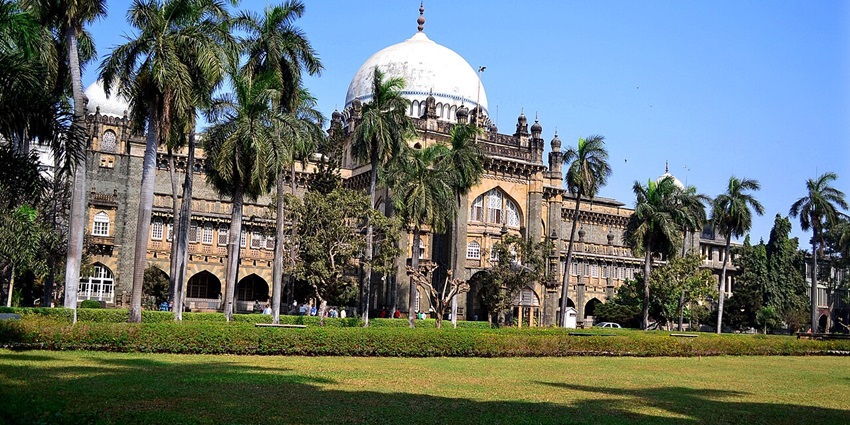 Exterior of Chhatrapati Shivaji Maharaj Vastu Sangrahalaya, Mumbai’s iconic museum, with tranquil landscape showing trees.
