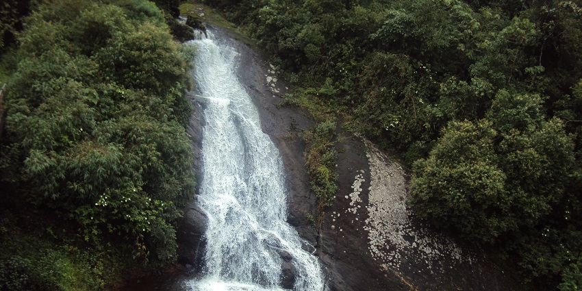 An image of Meghamalai Falls surrounded by lush greenery, highlighting stunning waterfalls.