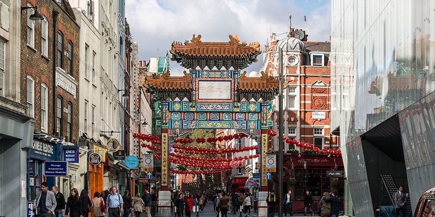 A beautiful view of a street in Chinatown decorated with Chinese lanterns for all.