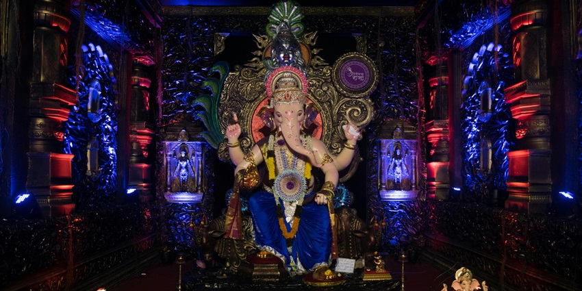 Temple scene: standing Ganesh idol richly decorated for Ganesh Chaturthi