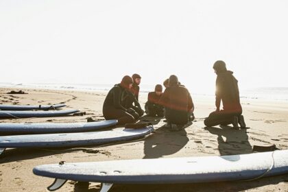 A picture of a vibrant crowd of people amidst Chivla Beach indulging in diverse water sports.