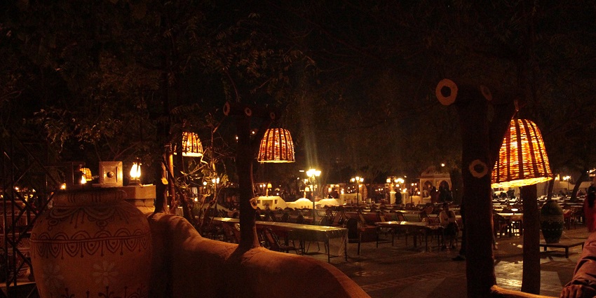 A vibrant night scene in Pune showcasing illuminated landmarks and bustling streets filled with people enjoying the nightlife