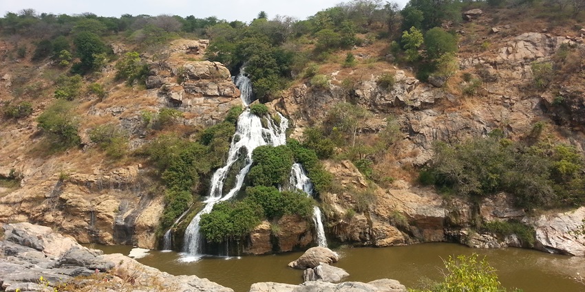 A view of the Chunchi Falls featuring majestic peaks, tranquil waterfalls, and greenery.