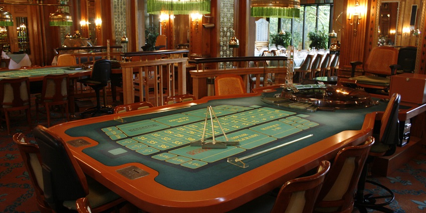 A roulette table with a spinning wheel and colorful betting layout.