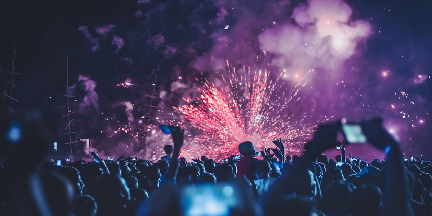 A view of people clicking pictures during fireworks at the party