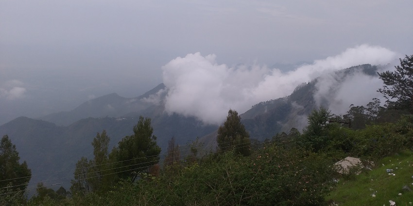 Places to visit near Kodaikanal feature scenic pathways with breathtaking views of Kodaikanal and surroundings.