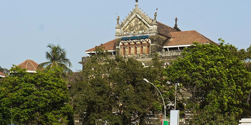 An image view of Colaba Causeway with colourful shops and bustling pedestrians.