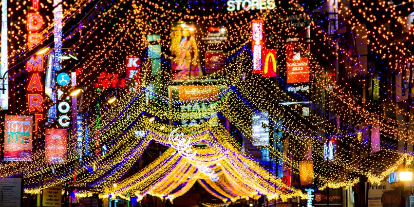 A glimpse of vibrant beauty of Commercial Street bustling wiith vibrant neon lights.