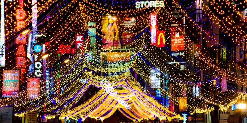 Illuminated Commercial Street at night, a place to visit especially during Eid
