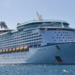 A view of a gigantic ship sailing through the shimmering blue waters in the region.