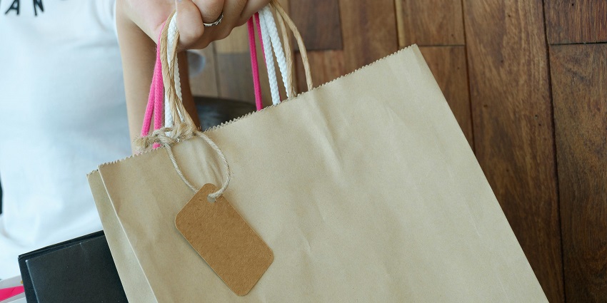 Image of person holding paper shopping bags in a mall - visit the best malls in Jalandhar