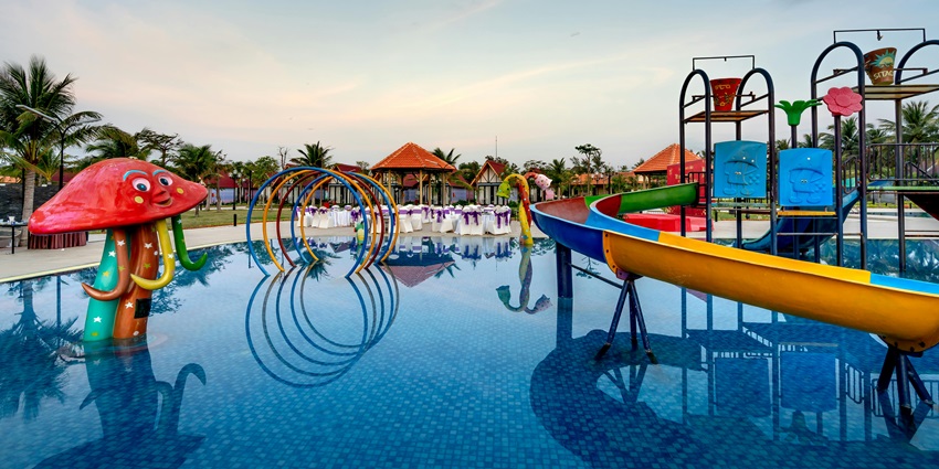 An image featuring a large pool and colourful water slides, making it the best fun place.