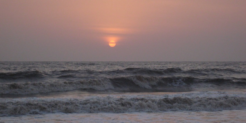 Sunset at Dahanu Beach, perfect for camping in Palghar with waves hitting the shore.