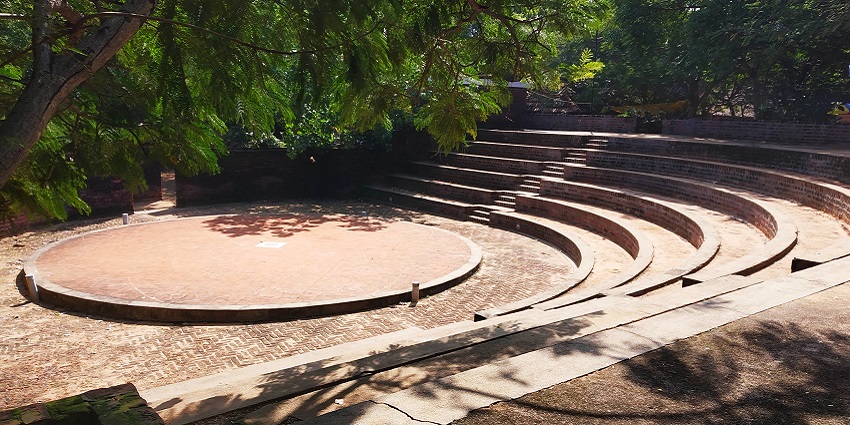 Outdoor amphitheatre with stone seating at DakshinaChitra, Tamil Nadu.