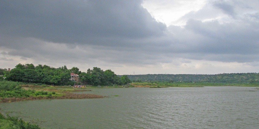Picturesque view of the Damdama lake, surrounded by lush greenery