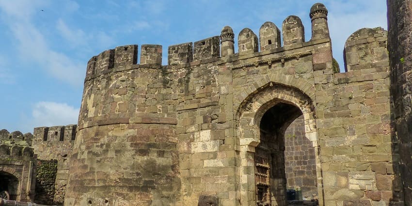 Fortified gateway with a large arched entrance, tourist attraction near Pitalkhora Caves.