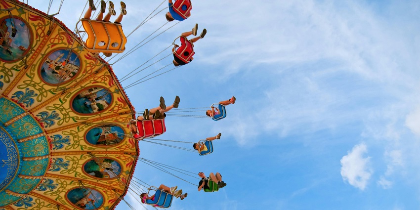 Image of several people enjoying a ride on a carousel in a waterpark near Lonavala.