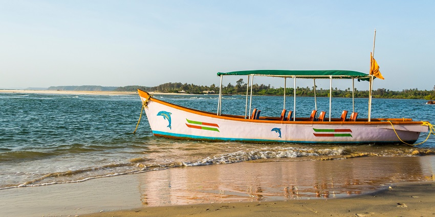 A peaceful, white sandy beach with clear waters and stunning views.