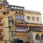 Badal Mahal in Deogarh Fort with intricate stone architecture surrounded by hilly terrain